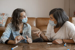 Woman showing to the other the negative Coronavirus results in t